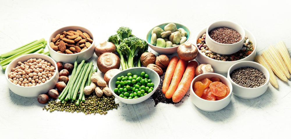 Variety of plant-based foods on a white background.